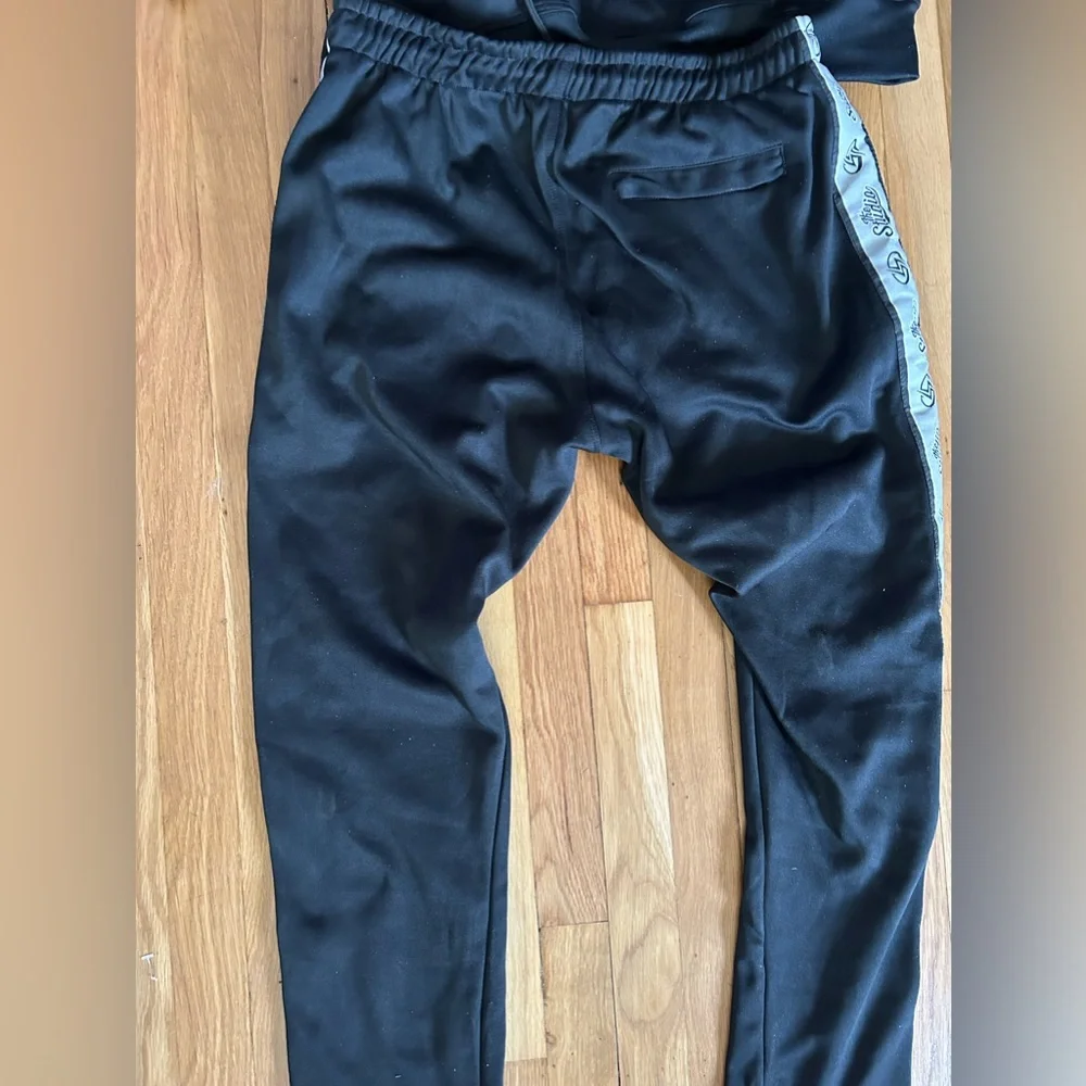 New in the bag black sweatshirt and sweatpants sealed in package.  Sz S, Med, XL - Picture 8 of 13